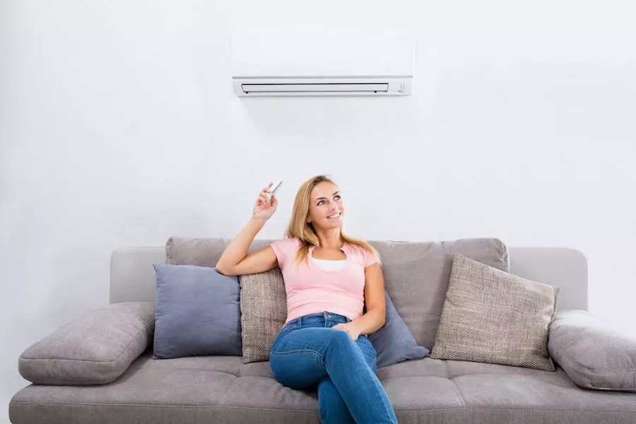  Image of a person sitting on a couch below a ductless system. Planning to Remodel? Go Ductless! 