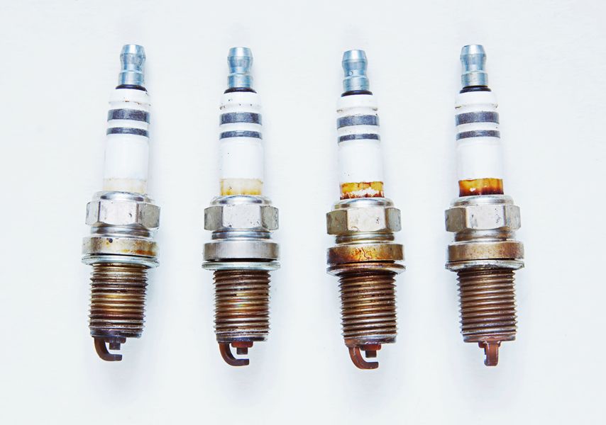 Maintaining Your Generator. Image is a photograph of four spark plugs on a white background.